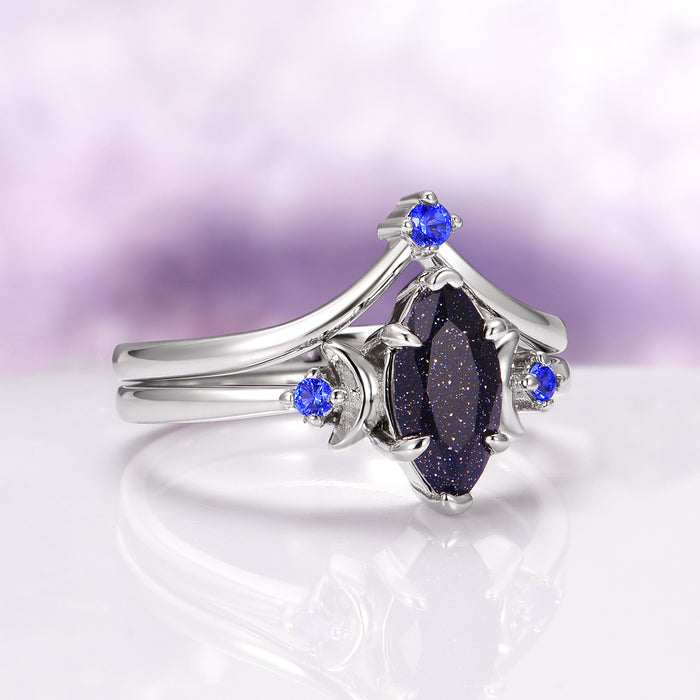 Lunar Starlight Sandstone Ring Set (Starry Night) in 14K White Gold by Aquamarise Gold, featuring a marquise-cut blue sandstone with sparkling flecks and accented by vibrant blue stones on elegant white gold bands, part of Non-Traditional Gemstone Engagement Rings and Starry Night™ Rings collections.