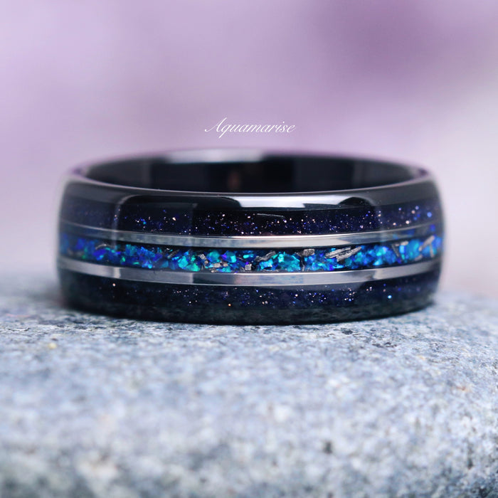 Starry Night and Fire Opal Leaf Couples Ring Set by Aquamarise featuring a black band with shimmering galaxy sandstone and vibrant blue fire opal inlay, part of Matching Couples' Rings, Starry Night™ Rings, and Fantasy-Inspired Jewelry collections.