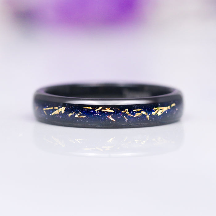 Stardust Couples Ring Set by Aquamarise featuring a sleek black finish band with sparkling deep blue and scattered gold fleck inlays, part of Matching Couples' Rings, Best Selling Jewelry, and Black Finish Rings collections.