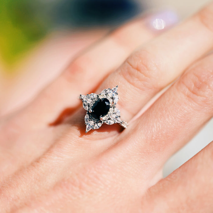 Stella Black Moissanite Engagement Ring in 14K White Gold by Aquamarise Gold featuring an oval black moissanite center with sparkling accents on a delicate white gold band.