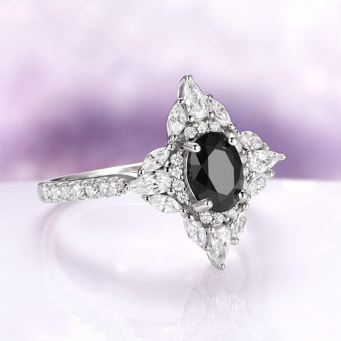 Stella Black Moissanite Engagement Ring in 14K White Gold by Aquamarise Gold featuring an oval black moissanite center with marquise and round white accents on a polished band.