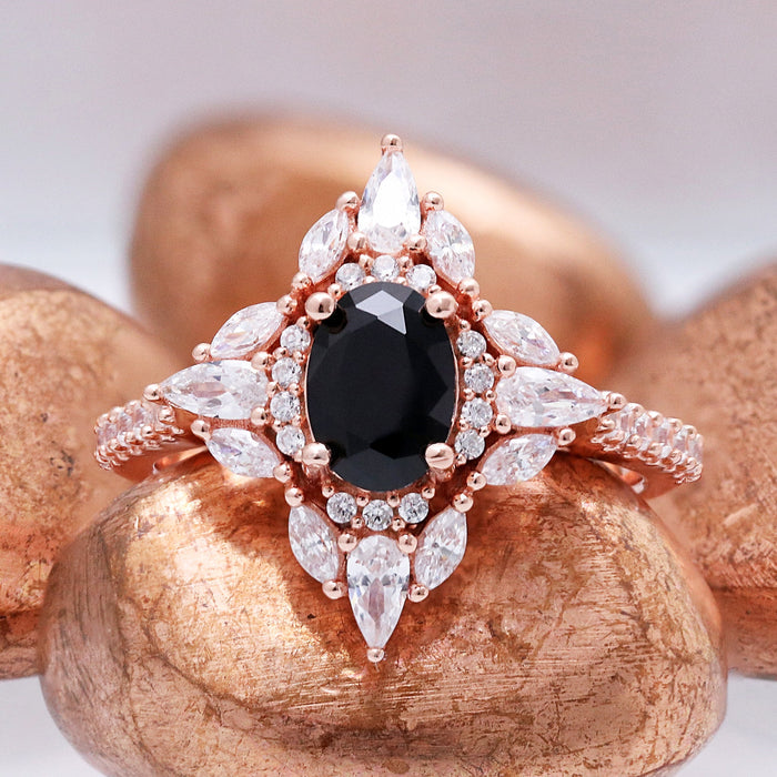 Close-up of the Stella black onyx ring in 14K rose gold vermeil, oval black onyx set in a marquise and round halo