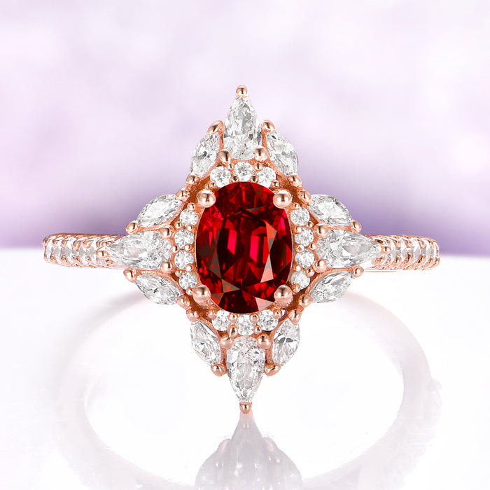 Stella Natural Red Garnet Ring in 14K Rose Gold Vermeil by Aquamarise, featuring an oval red garnet in a north-star halo of marquise and round accents.