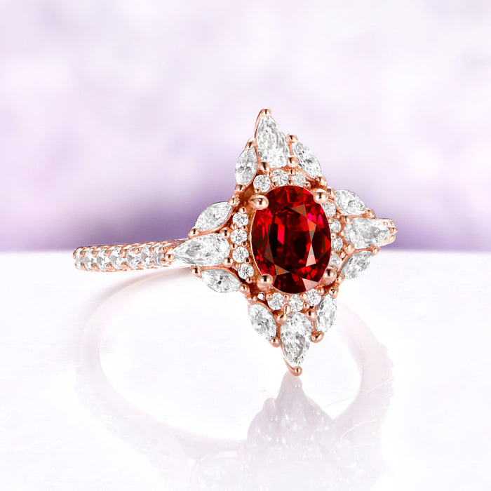 Stella Natural Red Garnet Ring in 14K Rose Gold Vermeil by Aquamarise, angled view showing the deep red oval garnet and star-shaped halo.