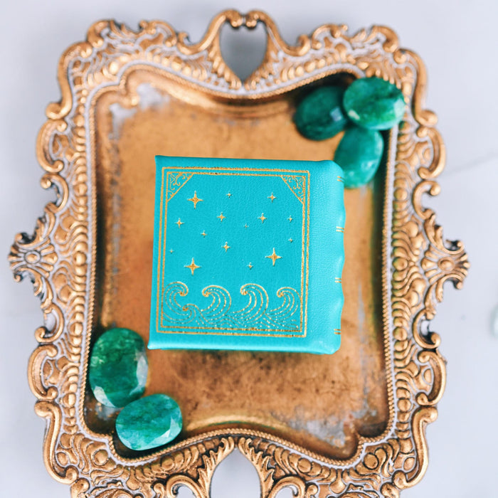 Summer Court Handmade Leather Book Ring Box- Ocean Tide Teal Edition (Small) on ornate gold tray with green stones, by Aquamarise, from Ring Boxes & Keepsake Proposals collection.