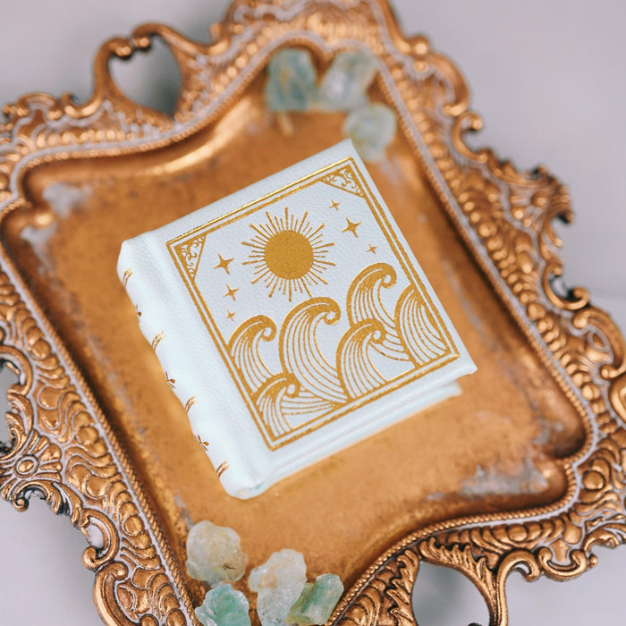 Summer Court Handmade Leather Book Ring Box- Seaglass Glow Edition (Small) by Aquamarise displayed on ornate gold tray with sea glass, part of Ring Boxes & Keepsake Proposals collection.
