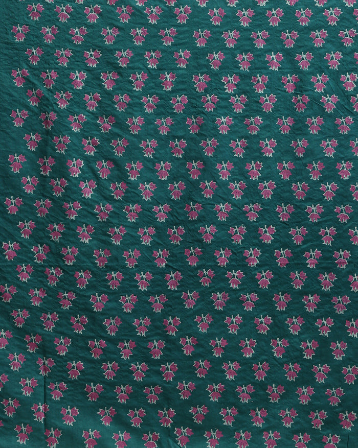 Teal green katan silk unstitched suit set with contrasting pink and white floral hand block print and a rectangular geometric frame bordering the dupatta.