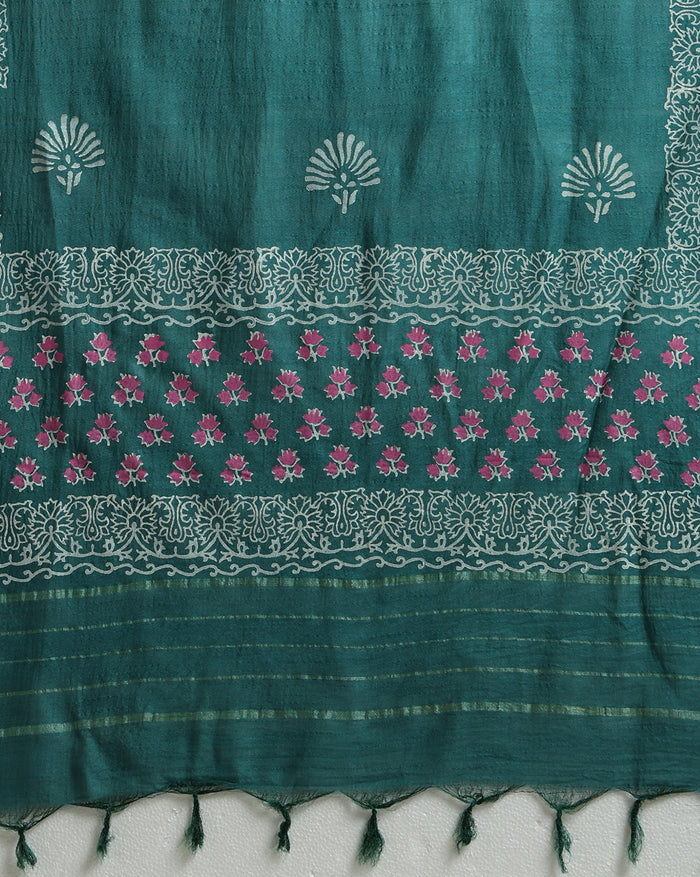Teal green katan silk unstitched suit set with contrasting pink and white floral hand block print and a rectangular geometric frame bordering the dupatta.