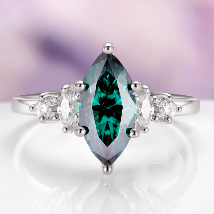 Teal Moissanite Marquise Engagement Ring in 14K White Gold by Aquamarise Gold, featuring a striking marquise teal moissanite center stone flanked by sparkling colorless moissanite accents, a unique design from the Solid Gold Moissanite Engagement Rings collection.