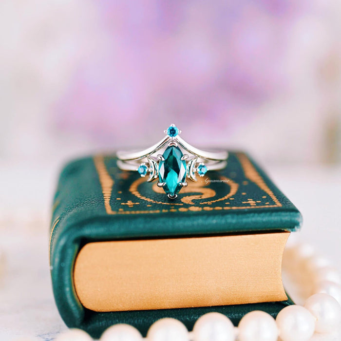 Teal Sapphire Crescent Moon Ring Set in 14K White Gold featuring a marquise-cut teal sapphire center with delicate crescent moon and smaller teal sapphire accents, crafted by Aquamarise Gold, from nature and fantasy-inspired collections.
