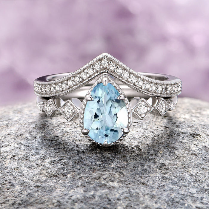 Teardrop Aquamarine Engagement Ring Set in 14K White Gold by Aquamarise Gold, showcasing a pear-shaped aquamarine center stone with diamond accents and a unique geometric diamond-accented band, part of Solid Gold Engagement Rings, March Birthstone Jewelry, and Alternative Engagement Rings collections.