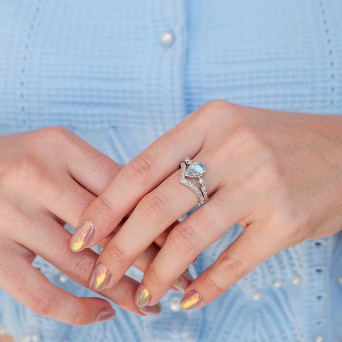 Teardrop Aquamarine Engagement Ring Set in 14K White Gold by Aquamarise Gold, featuring a pear-shaped aquamarine center stone with diamond accents on a chevron-patterned white gold band, part of March Birthstone Jewelry and Alternative Engagement Rings collections.