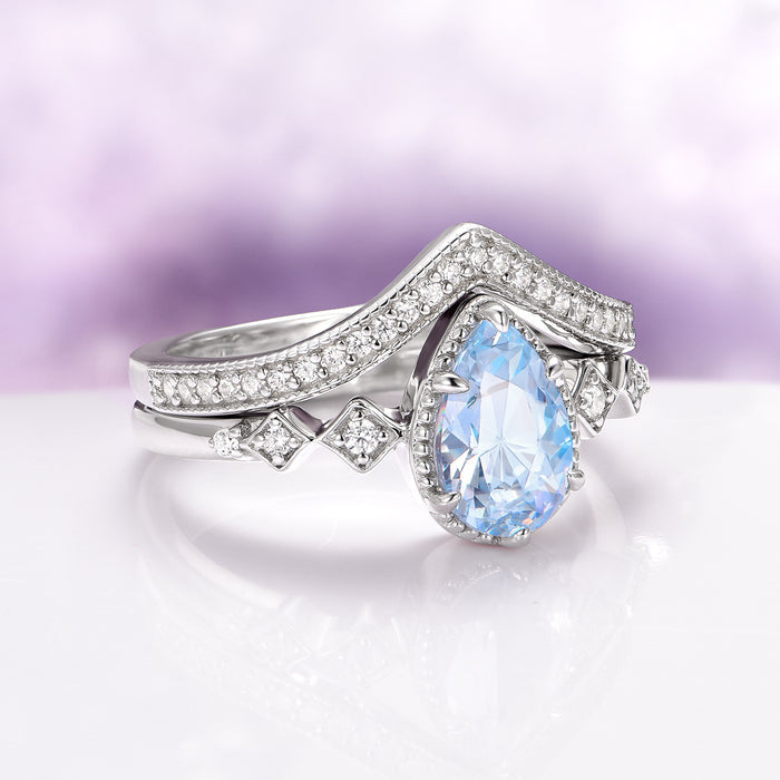 Teardrop Aquamarine Engagement Ring Set in 14K White Gold by Aquamarise Gold, featuring a pear-shaped aquamarine center stone with delicate diamond accents on a curved white gold band, part of March Birthstone Jewelry and Alternative Engagement Rings collections.