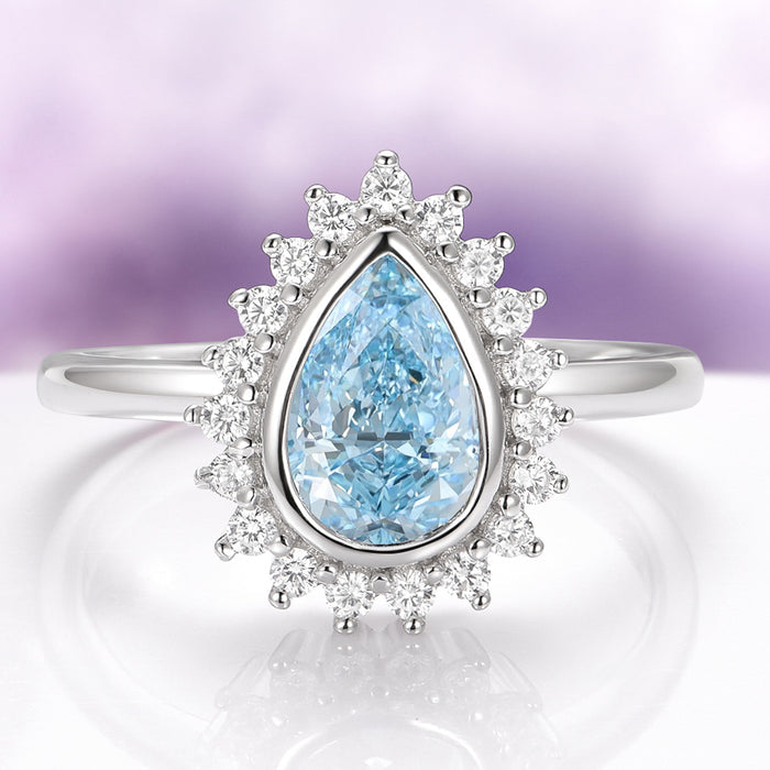 Teardrop Bezel Aquamarine Ring in Sterling Silver featuring a lab-created aquamarine surrounded by sparkling accents, combining vintage charm with a modern minimalist design by Aquamarise.