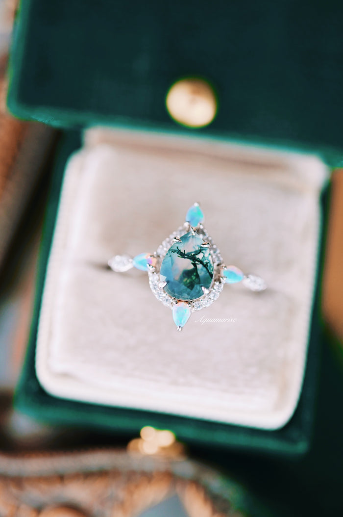 Green Moss Agate & Fire Opal Engagement Ring- 14K White Gold featuring a teardrop moss agate center stone with intricate natural inclusions, surrounded by sparkling diamonds and accented by glowing fire opal marquise gems, crafted by Aquamarise Gold.
