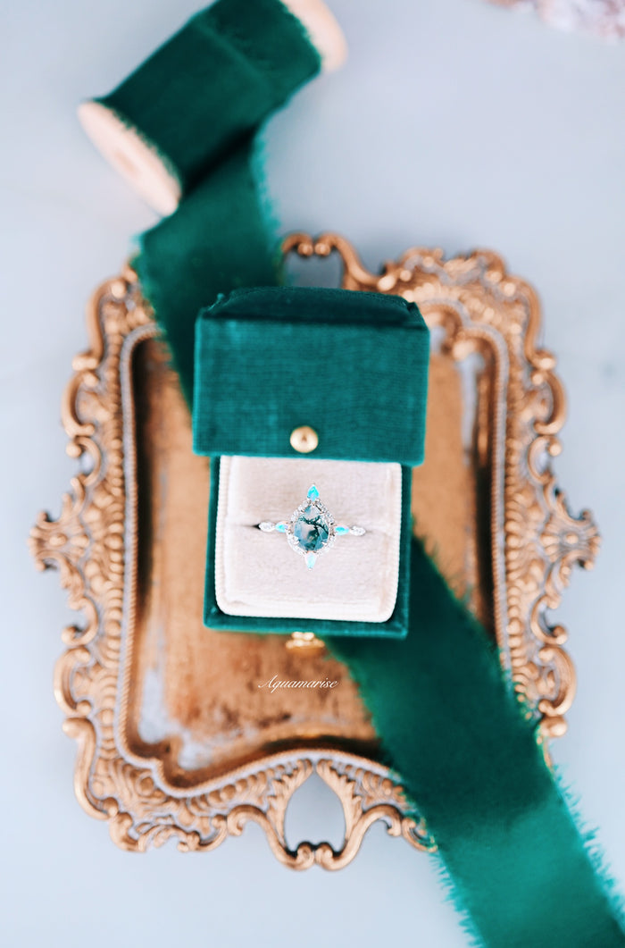 Green Moss Agate & Fire Opal Engagement Ring- 14K White Gold with a unique teardrop moss agate centerpiece accented by delicate fire opal gems and diamonds, presented in a luxurious green velvet box by Aquamarise Gold.