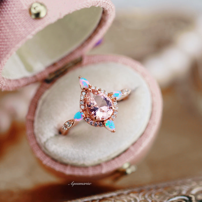 Teardrop Morganite & Fire Opal Engagement Ring in 14K Solid Rose Gold by Aquamarise Gold featuring a pear-shaped morganite with fire opal and diamond accents in a pink ring box.