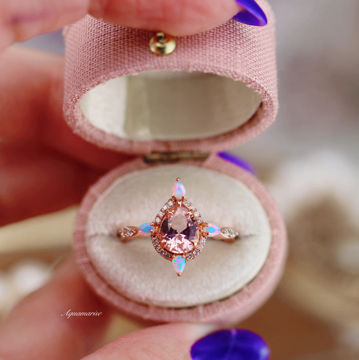 Teardrop Morganite & Fire Opal Engagement Ring in 14K Solid Rose Gold by Aquamarise Gold featuring a pear-shaped morganite with vibrant fire opal accents in a pink velvet ring box.