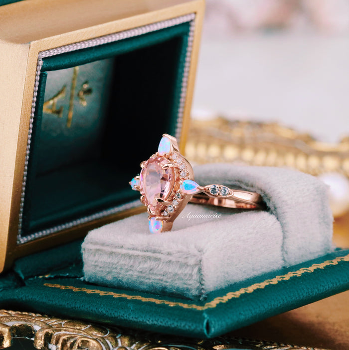 Teardrop Morganite & Fire Opal Engagement Ring in 14K Solid Rose Gold by Aquamarise Gold featuring a pear-shaped morganite and glowing fire opal accents in a green velvet ring box.