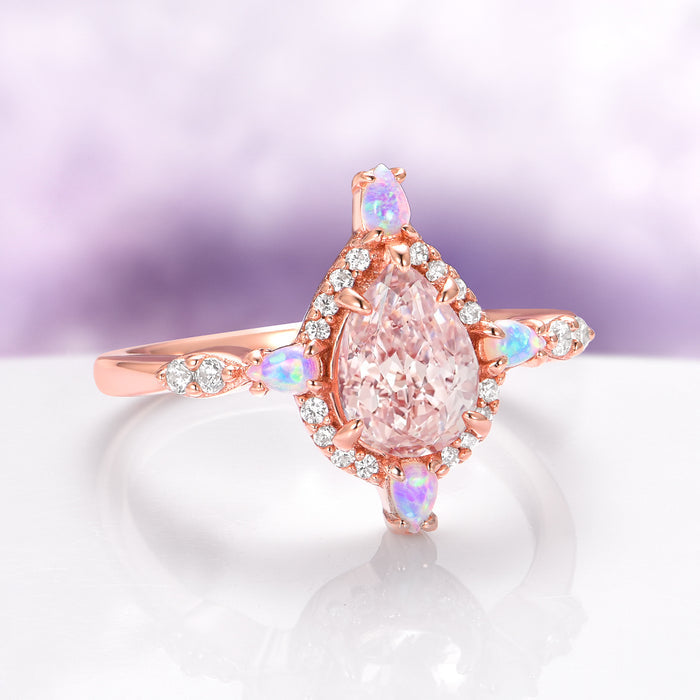 Teardrop Morganite & Fire Opal Engagement Ring in 14K Solid Rose Gold by Aquamarise Gold featuring a pear-cut morganite surrounded by diamonds and fire opals on a rose gold band.