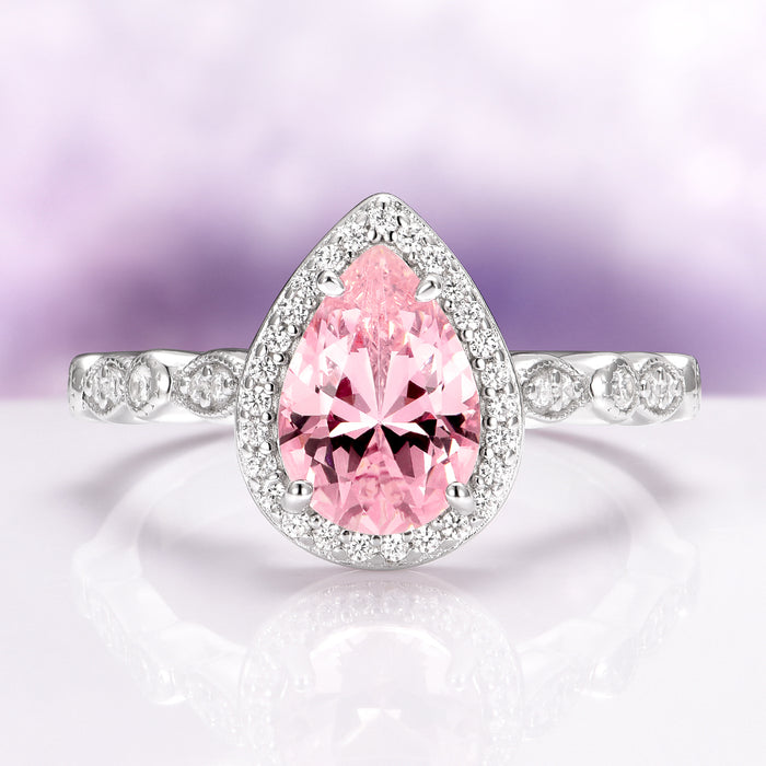 Teardrop Pink Sapphire Ring in Sterling Silver by Aquamarise featuring a vintage-inspired pear-shaped pink sapphire center surrounded by a halo of sparkling stones on a polished silver band, part of Sterling Silver Rings and September Birthstone Jewelry collections.