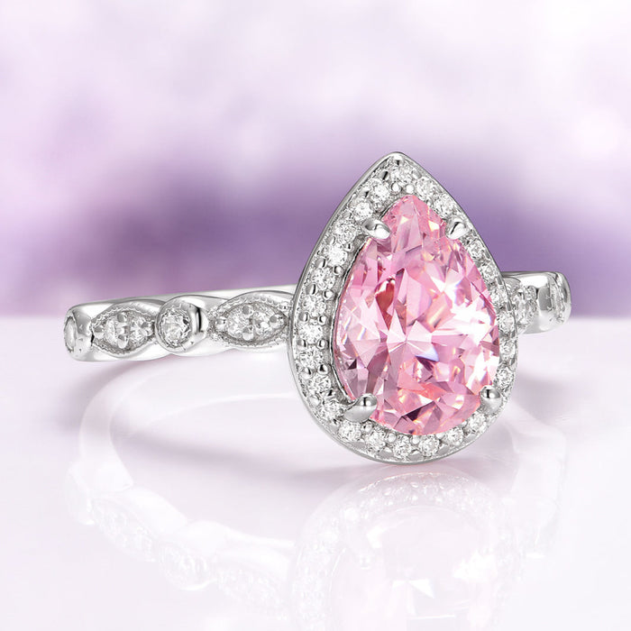Teardrop Pink Sapphire Ring in Sterling Silver by Aquamarise, showcasing a radiant pear-shaped pink sapphire surrounded by a halo of sparkling stones on a detailed sterling silver band, part of Sterling Silver Rings and September Birthstone Jewelry collections.