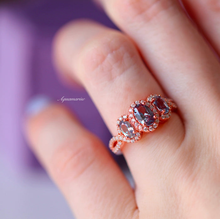 Three Stone Alexandrite Ring in 14K Rose Gold Vermeil by Aquamarise showcasing three oval lab-grown alexandrite stones with diamond halos on a detailed rose gold vermeil band.