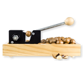 A nut cracker with a lever and wooden body, with nuts collected in a tray underneath.