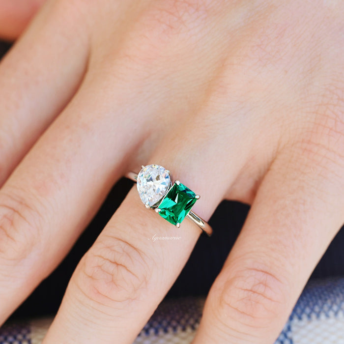 Toi Et Moi Emerald and Moissanite Ring- 14K White Gold featuring a pear-shaped moissanite and an emerald-cut green emerald on a white gold band by Aquamarise Gold.