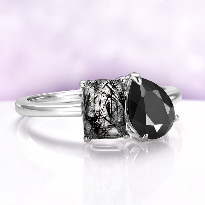 Toi Et Moi Rutilated Quartz & Black Onyx Engagement Ring in 14K White Gold, featuring a natural emerald-cut rutilated quartz and pear-shaped black onyx in a delicate solid gold band.