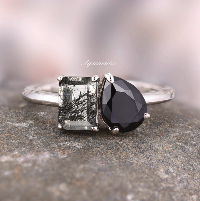 Toi Et Moi Rutilated Quartz & Black Onyx Ring- 14K White Gold by Aquamarise Gold, featuring a rectangular rutilated quartz and pear-shaped black onyx set on a sleek white gold band.