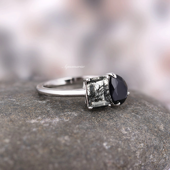 Toi Et Moi Rutilated Quartz & Black Onyx Ring- 14K White Gold by Aquamarise Gold, showcasing two contrasting gemstones set on a polished white gold band, styled on a natural stone surface.