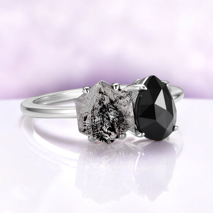 Toi Et Moi Salt & Pepper Herkimer Diamond & Black Onyx Ring in 14K White Gold by Aquamarise Gold, featuring a hexagon Herkimer diamond and pear-shaped black onyx in a gothic design.