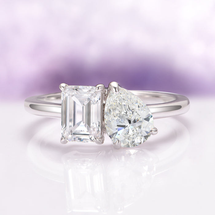 Toi Et Moi Lab-Grown Diamond Engagement Ring in 14K White Gold (IGI Certified) by Aquamarise Gold features a modern design with two IGI-certified lab-grown diamonds, including an emerald cut and a pear-shaped stone, set on a sleek white gold band.