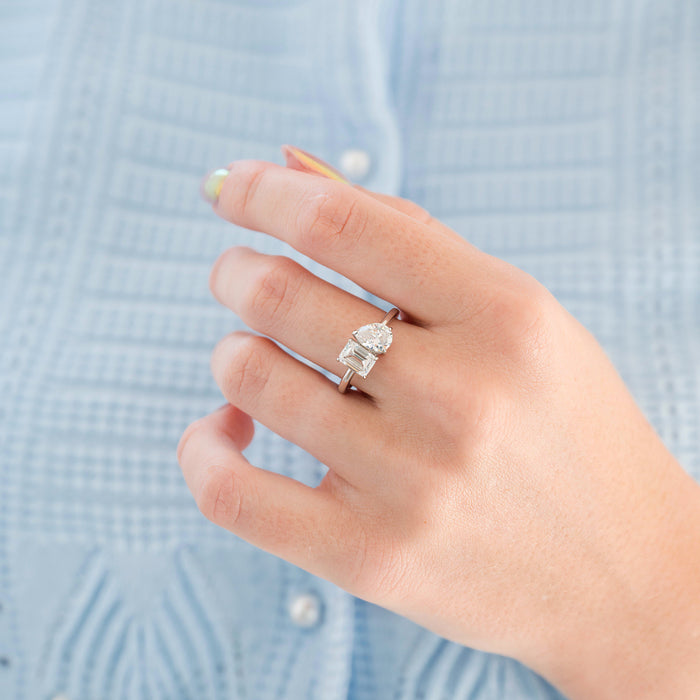 Toi Et Moi Lab-Grown Diamond Engagement Ring in 14K White Gold (IGI Certified) by Aquamarise Gold features a romantic design with pear-shaped and emerald-cut lab-grown diamonds set on a polished white gold band.