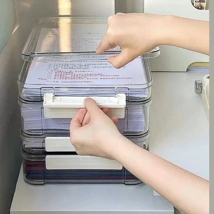 Transparent document storage box being opened to access organized paperwork.