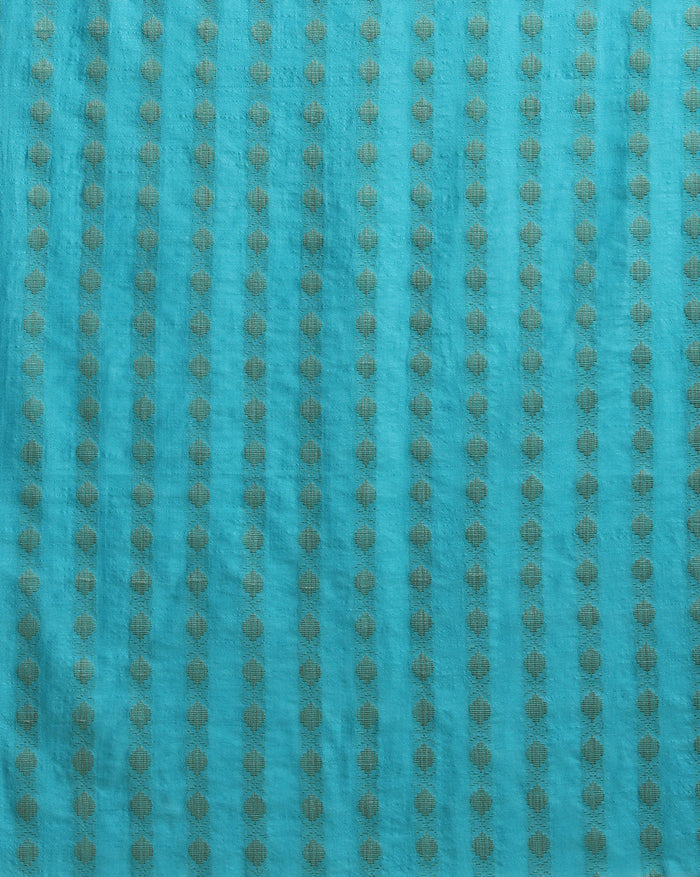 Unstitched turquoise Katan silk suit set with banded geometric stripes on the top and dense paisley-like floral block print on the dupatta, finished with a decorative border strip and fringed ends.