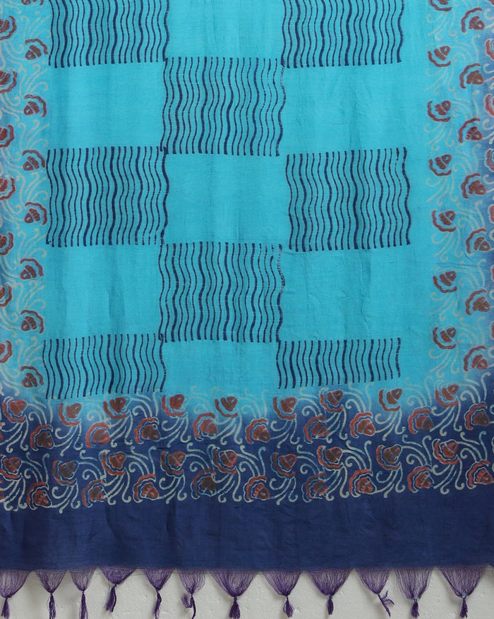 Unstitched turquoise Katan silk suit set with banded geometric stripes on the top and dense paisley-like floral block print on the dupatta, finished with a decorative border strip and fringed ends.