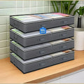 Under-bed storage bags for bedding stacked on a kitchen counter, 4 pack design perfect for quilts and seasonal clothing.