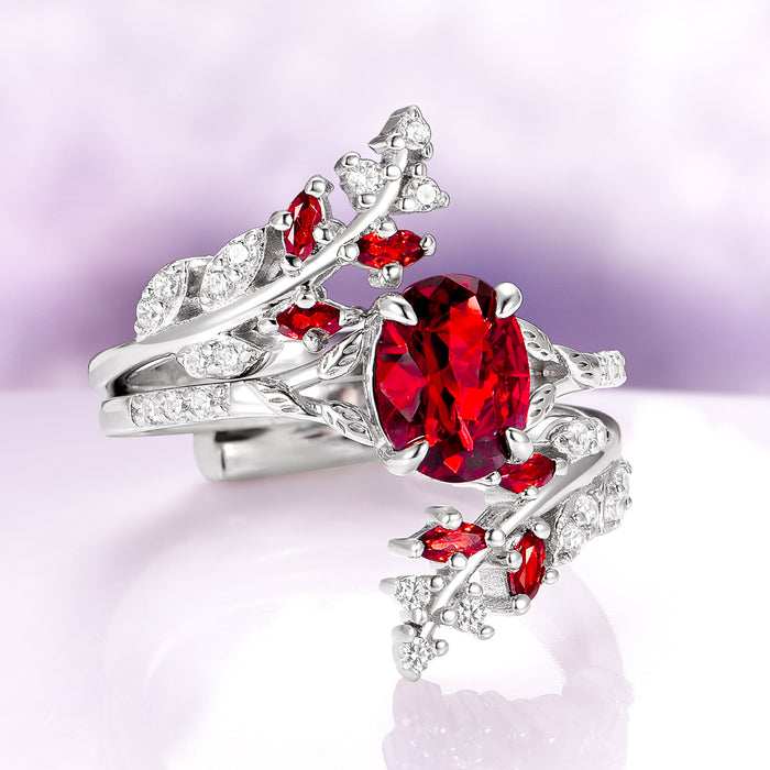Fireworks Cut Natural Red Garnet Leaf Engagement Ring in 14K White Gold by Aquamarise Gold, featuring a vibrant oval red garnet centerpiece accented with intricate white gold leaf motifs and small diamond details, part of Solid Gold Engagement Rings and January Birthstone Jewelry collections.
