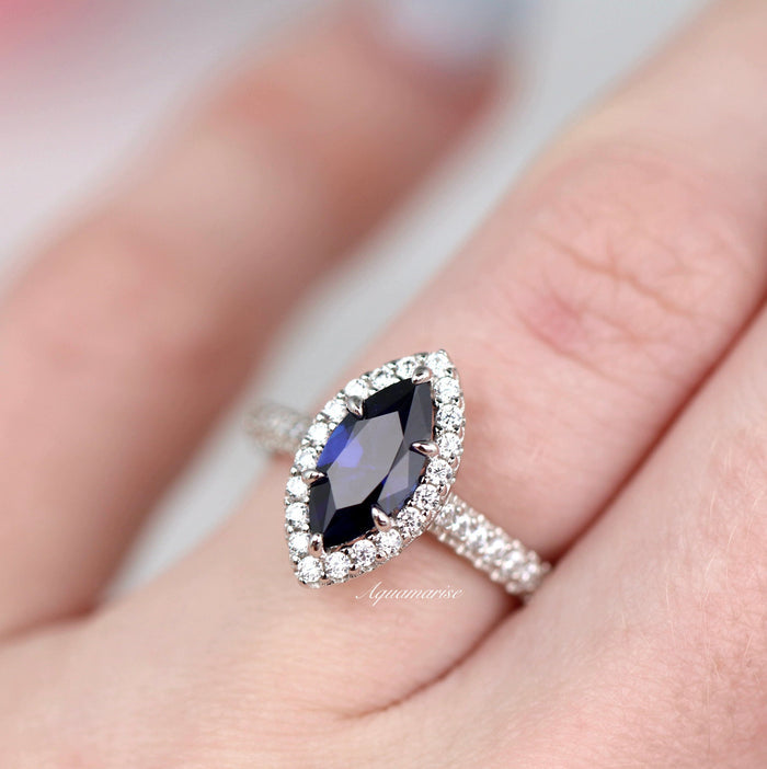 Valeria Marquise Halo Blue Sapphire Ring- Sterling Silver by Aquamarise, showcasing a marquise royal blue sapphire with a sparkling diamond halo on a sterling silver band.