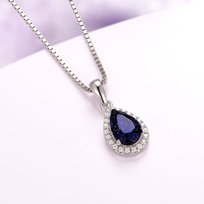 Vera Starry Night Necklace in Sterling Silver by Aquamarise featuring a pear-shaped dark blue sandstone pendant framed with sparkling crystals in a celestial-inspired design.
