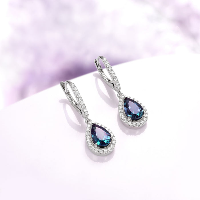 Vera Teardrop Lab-Grown Alexandrite Drop Earrings in Sterling Silver by Aquamarise, featuring sparkling teardrop alexandrite gemstones surrounded by shimmering silver and diamond accents.
