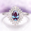 Victoria Art Deco Alexandrite Engagement Ring in 14K White Gold by Aquamarise Gold featuring an oval alexandrite framed by radiant moissanite accents in a vintage-inspired design.