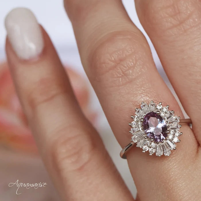 Victoria Art Deco Alexandrite Engagement Ring in Sterling Silver by Aquamarise featuring a lab-grown oval alexandrite center with intricate halo of baguette and round accents on a vintage-inspired band.