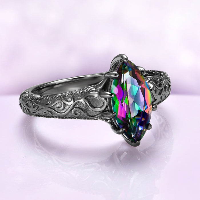 Victorian Gothic Mystic Topaz Filigree Engagement Ring in Black Ruthenium by Aquamarise featuring a marquise mystic topaz and engraved Victorian scrollwork on a black ruthenium sterling silver band.