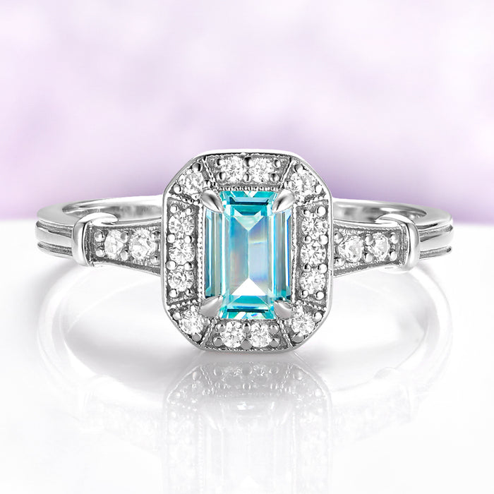 Vintage Halo Aquamarine Ring in Sterling Silver by Aquamarise, featuring a vintage-inspired emerald-cut aquamarine surrounded by a milgrain-edged halo with pavé-set shoulders.
