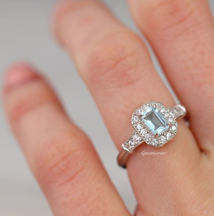 Cynthia Aquamarine Ring- Sterling Silver by Aquamarise featuring an emerald-cut aquamarine center surrounded by a pavé diamond halo on a polished sterling silver band.