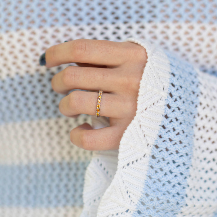 Vintage Natural Citrine Band in Sterling Silver by Aquamarise displayed on a hand wearing a white knit sweater, featuring warm golden citrine gemstones set in a delicate sterling silver band, perfect for November birthstone jewelry.