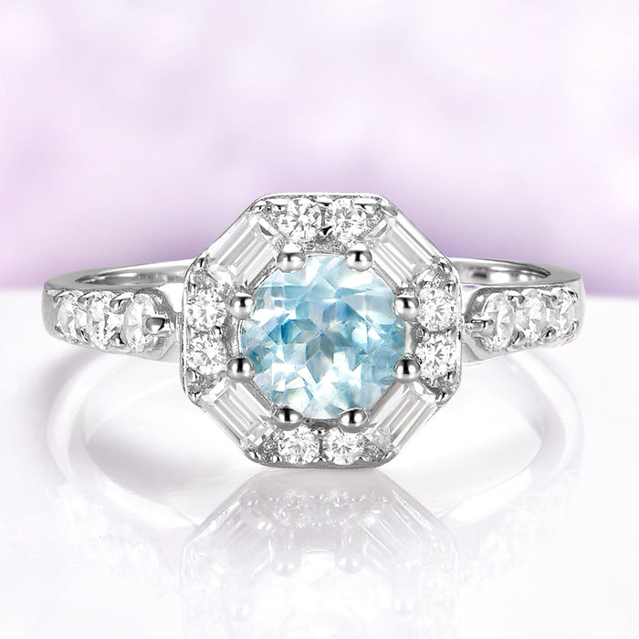 Vintage Octagon Halo Round Aquamarine Ring in Sterling Silver by Aquamarise, featuring a 0.85 carat aquamarine center with baguette and round simulated diamonds in a vintage halo design.